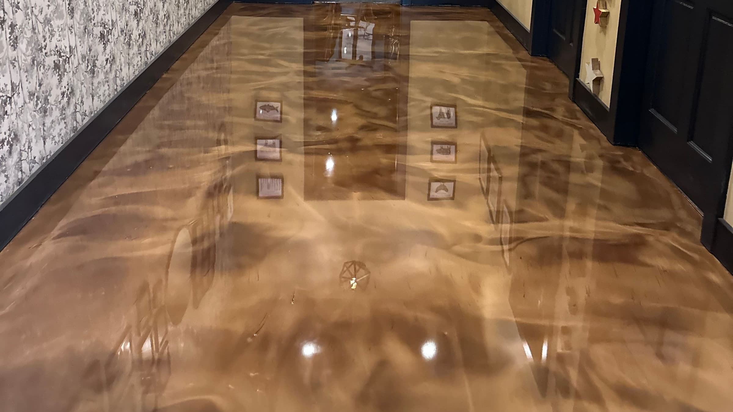 Bronze metallic epoxy floor with hand-moved pigment swirls